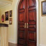 Arched top custom paneled doors in walnut
