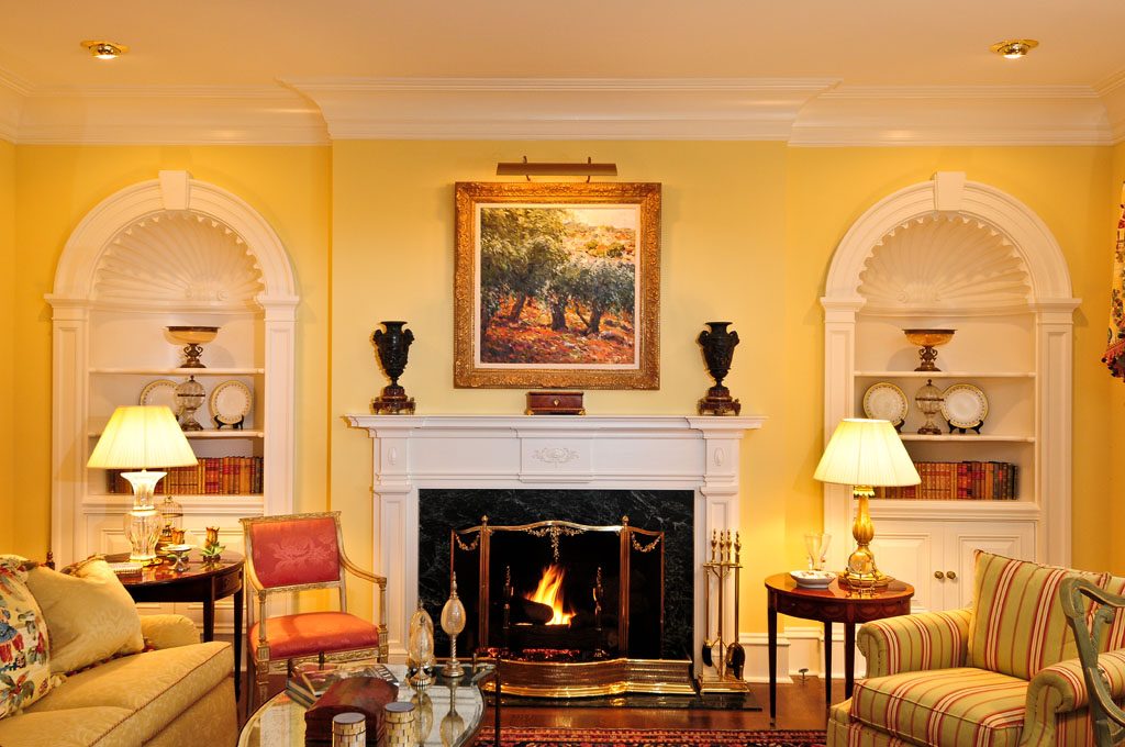 Concave shell niche bookshelves and Federal style fireplace with massive crown cove molding