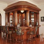 Walnut custom home bar with square, fluted, columns and paneling