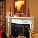 Elegant, simple mantelpiece paired with dramatic cove crown moulding