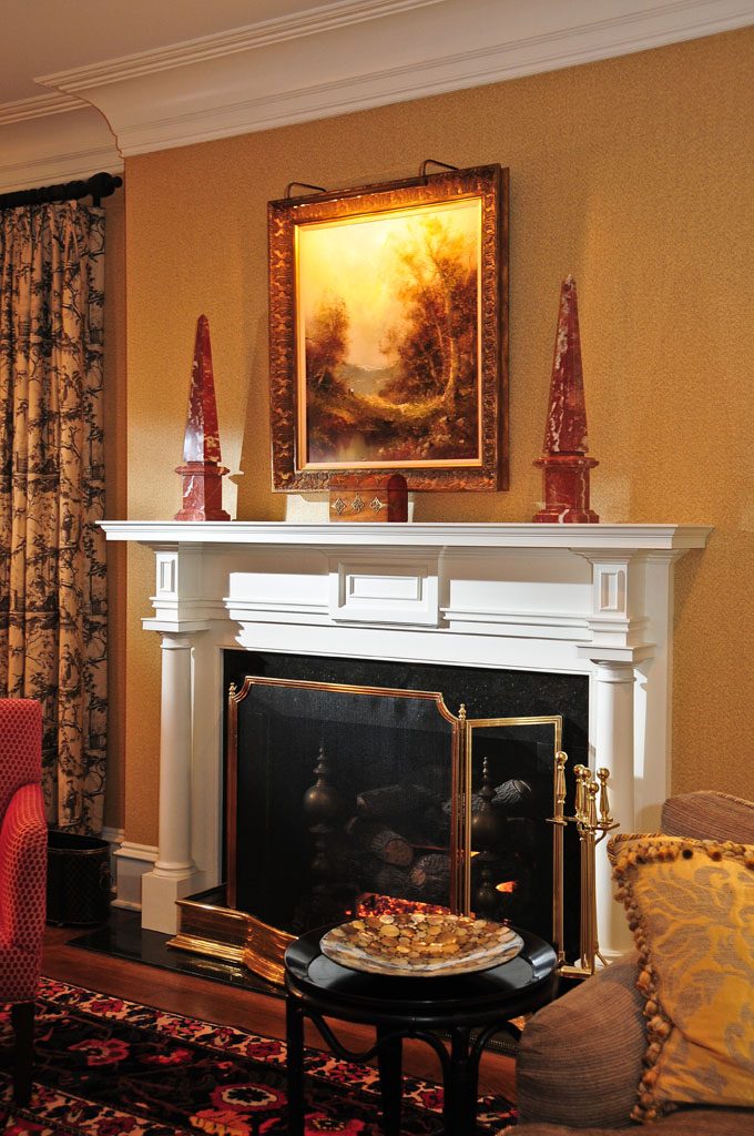Elegant, simple mantelpiece paired with dramatic cove crown moulding