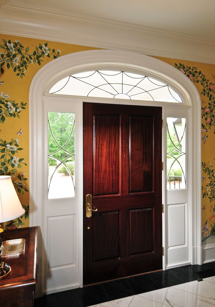 Fanlight overdoor with a 4 over 4 paneled mahogany entrance