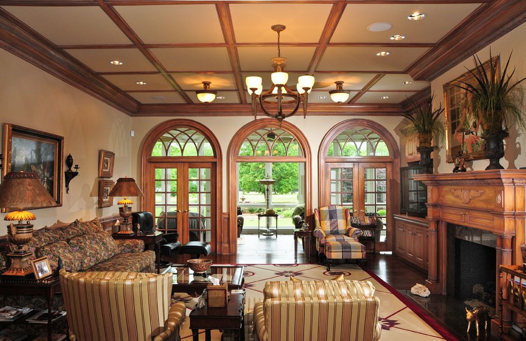 Stain grade mouldings in custom library with coffered ceiling; Palladian doors.