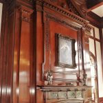 Walnut Chippendale style over mantel with applied pilasters, dentil moulding, broken pediment.